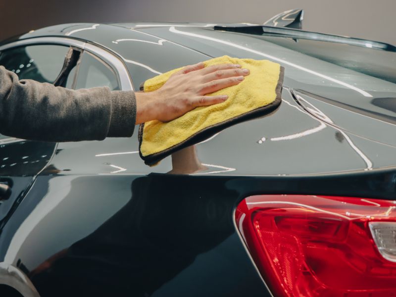 Mobile car detailing in progress on a black SUV in an Auckland driveway